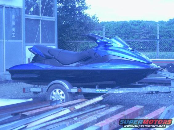 Blue jet ski on a trailer, side view